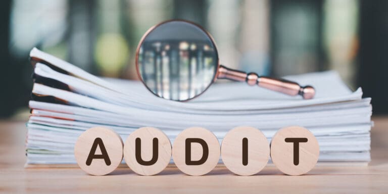 concept of quality and efficiency auditing and evaluation documents and magnifying lens - Why an Internal Audit