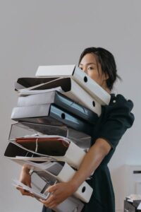 Woman carrying eight huge files