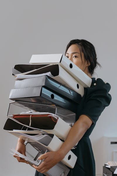 Woman carrying eight huge files - Small Business Document Management System