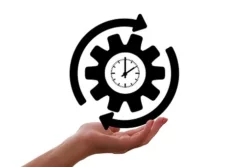 Hand holding up gear depicting process and time as a continuum - 8 Reasons Why Delegation Efforts Fail in Small Businesses