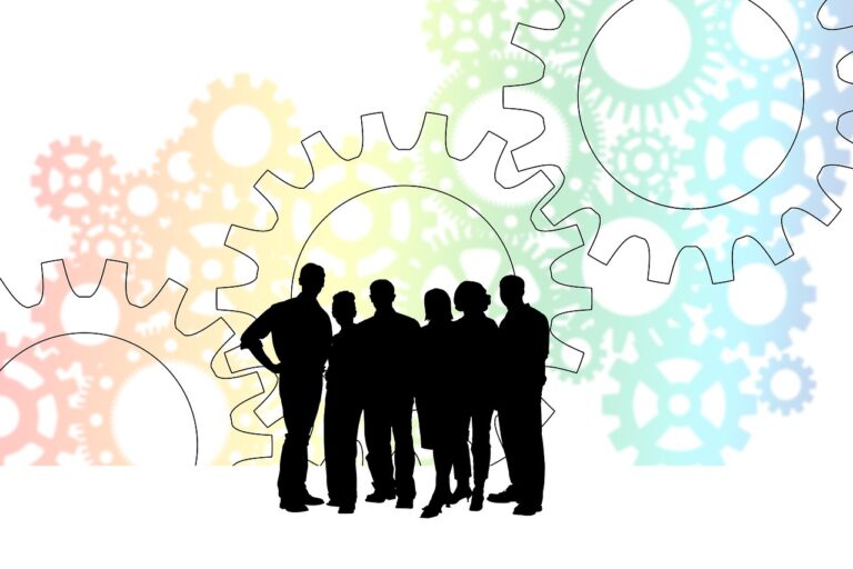 People in a business surrounded by work gears depicting processes and systems - What is Process Improvement in Business