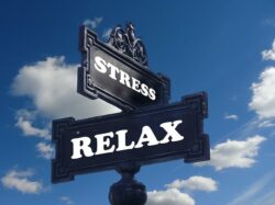 Cross road sign showing the words stress and relax