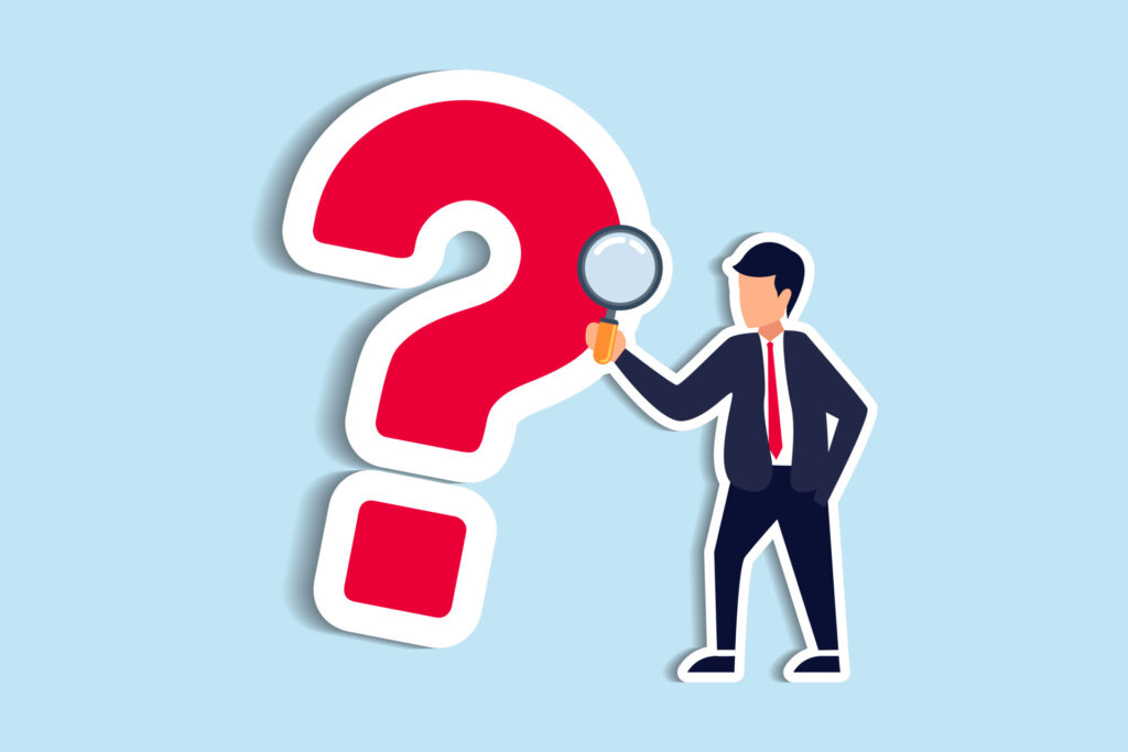 Man with magnifying glass peering at a giant red question mark