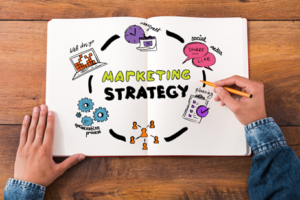 Marketing Strategy concept on a white sheet of paper held by a man - How to Create a Small Business Marketing Strategy