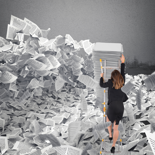 Businesswoman-using-a-ladder-to-climb-out-of-a-mountain-of-documents - Reasons for Going Paperless