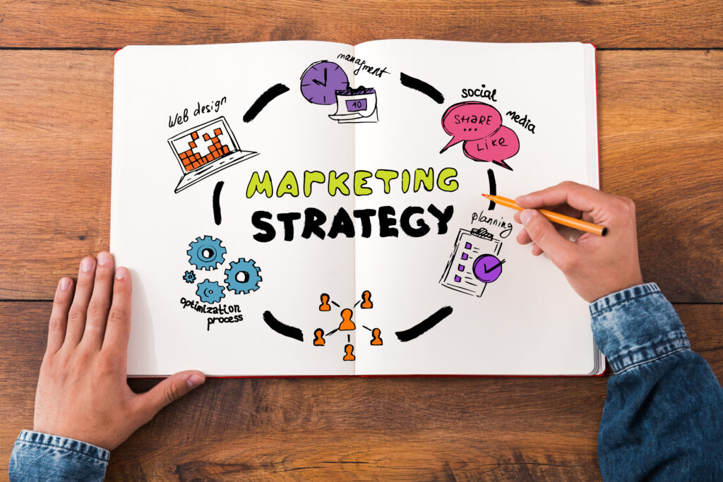 top-view-close-up-image-of-man-holding marketing-strategy- How to Fix 9 Overlooked Challenges in Small Business