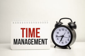 Time management words on a white notebook and clock - 8 Reasons Why Delegation Efforts Fail in Small Businesses