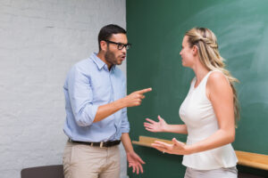 Two sibling business colleagues in heated argument - How to Resolve a Conflict in the Workplace