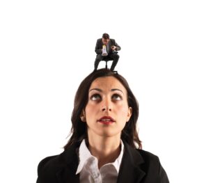 Boss sitting on the head of a female employees and screaming at her on the megaphone - Ways to Deal with Difficult People