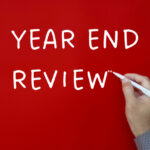 Year end review text written on red cover background - Business Strategy Review