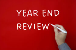 Year end review text written on red cover background - Business Strategy Review