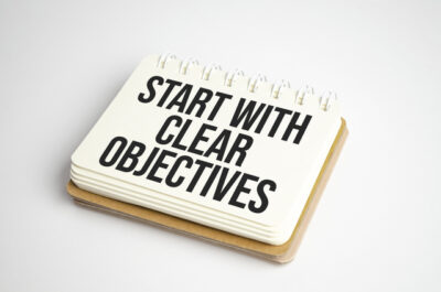 Business concept. Notebook with text START WITH CLEAR OBJECTIVES on sheet of white paper - Workflow Optimization
