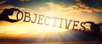Objectives - human hands holding black silhouette word - sunset sky in background - How to Use SMART Criteria to Set Objectives