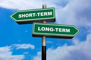Two direction signs with one pointing left for Short-Term and the other pointing right for Long-Term - How to Evaluate Small Business Performance
