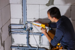 Male Plumber repairs pipes in the toilet - How to Treat the Role of a Small Business Owner