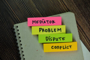 mediator, problem, dispute, conflict sticky notes isolated on wooden table - How to Protect Your Business in Vendor Contract Negotiation