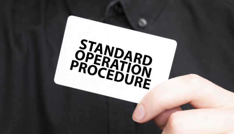 businessman holding a card with text standard operation procedure, business - How to Create an SOP Document