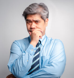 asian senior businessman in shirt and tie thinking against white background - How to Map a Business Process to Improve it