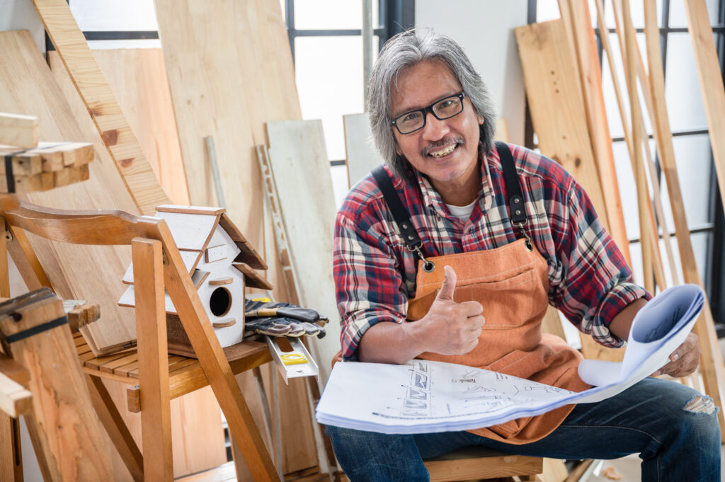 carpenter-holding-blueprint-in-workshop-How to Treat the Role of a Small Business Owner