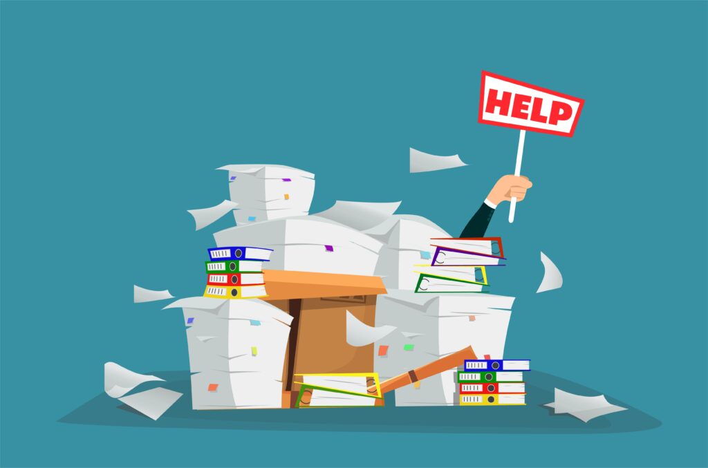 Hand buried under paperwork holding up a help sign - How to Fix Feeling Overwhelmed in Small Business