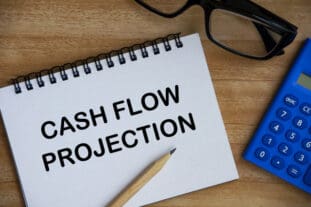 cash flow projection text on notepad with calculator, pencil and glasses background-How to Write a Small Business Plan