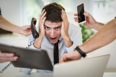overworked businessman - How to Avoid 7 Workflow Optimization Mistakes