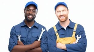 two-tradesmen-in-blue-overalls-standing-next-to-each-other-with-wrenches-in-both-hands- What Should be Included in The Company Overview Section
